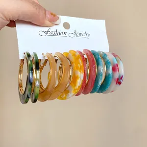 Detailed view of colorful acetate leopard print hoop earrings set shown on a display card