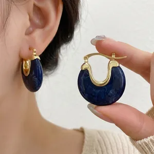Vintage gold geometric hoop earrings with elegant dark blue marbled resin insets