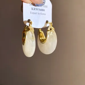 Minimalist vintage gold hoop earrings with cream resin inlay and 925 silver card
