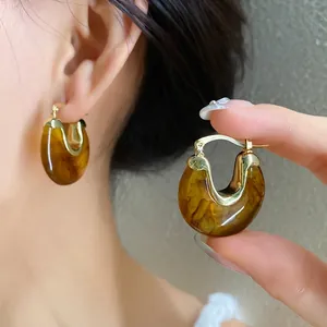 Vintage amber tortoiseshell resin hoop earrings with elegant gold-tone accents