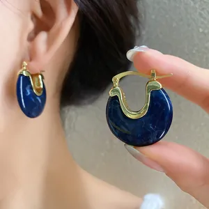 Close-up detail of vintage deep blue marbled resin geometric hoop earrings for women
