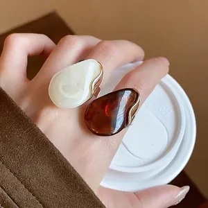 Stylish oversized resin oval open rings in amber and cream colors for fashionable women