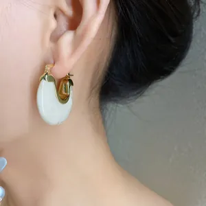 Detailed close-up of a vintage geometric resin hoop earring with elegant gold accents