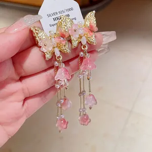 Elegant butterfly tassel earrings with pink crystals and pearls on silver needles.