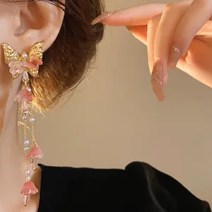 Elegant butterfly crystal tassel drop earrings shown on model for a graceful look.