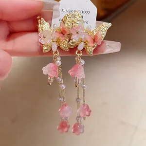 Macro view showing the exquisite butterfly crystal tassel earrings with S925 silver needle detail