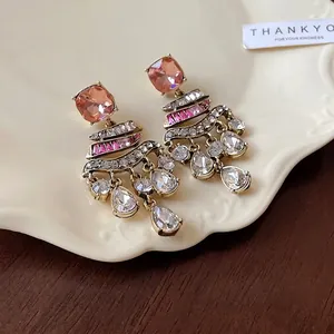 Vintage-style dangling earrings featuring pink crystals and clear water drop rhinestones