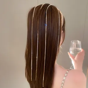 Elegante fascia multistrato con nappe di strass che scendono sui capelli castani