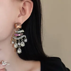 Close-up view of vintage rhinestone drop tassel earrings on an Asian model's ear