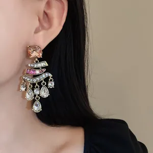 Close-up of vintage gold-tone earrings featuring sparkling colorful rhinestones detail