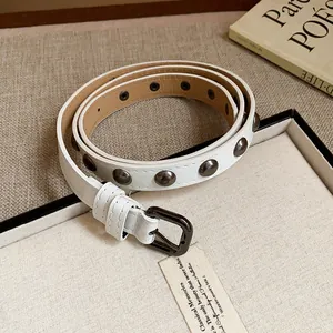 Detailed view of a white leather belt with round metallic rivets and a dark buckle.