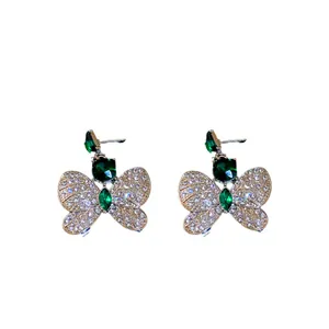 Elegant rhinestone butterfly drop earrings with green stones and sparkling crystals