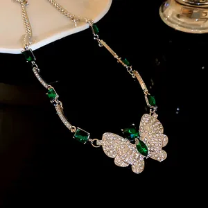 Elegant silver-toned necklace featuring an emerald green crystal butterfly pendant detail view