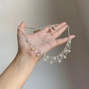 Detailed view of elegant faux pearl and rhinestone tassel necklace with matching earrings