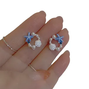 Elegant silver needle starfish and pearl wreath stud earrings for a summer beach look