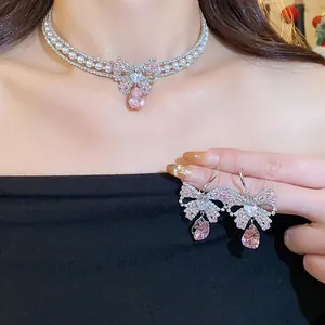 Detail showing elegant pink butterfly zircon jewelry set with pearl necklace and earrings