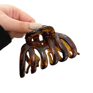 Minimalist amber tortoiseshell hair claw clip featuring a sleek Korean shark clip design