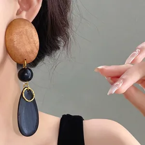Statement vintage wood bead earrings featuring oval and teardrop dangles for women.