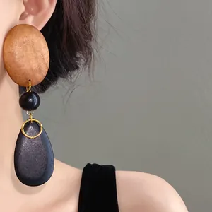 Close-up of vintage wooden teardrop earrings with oval and spherical beads