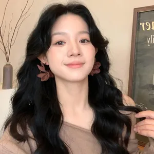 Close-up of elegant brown fabric flower clip-on earrings worn by an Asian model