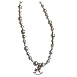 Elegant silver-plated beaded necklace featuring a charming rocking horse pendant