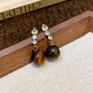 Eleganti orecchini in occhio di tigre con zirconi lucenti e finitura dorata di lusso.