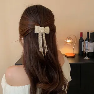 Elegant rhinestone bow tassel hair clip with sparkling crystals for a sophisticated look