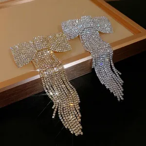 Elegant rhinestone bow hair clip featuring sparkling long tassels in gold and silver