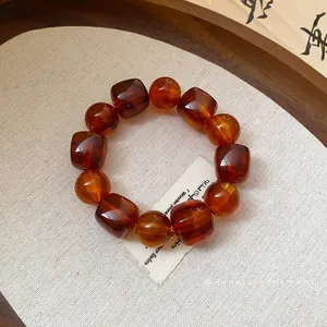Elegant amber acrylic beaded bracelet featuring irregular geometric and round beads