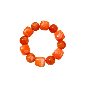 Chic orange acrylic beaded bracelet featuring irregular geometric marbled beads design