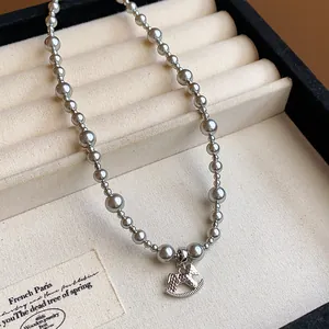 Detailed view of an elegant silver beaded necklace featuring a charming rocking horse pendant