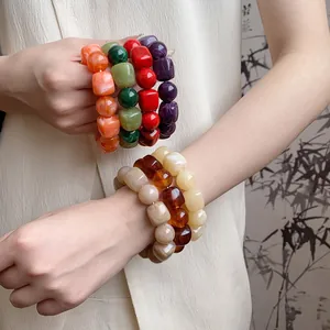 Detailed macro view showing various colors of acrylic irregular geometric beaded bracelets