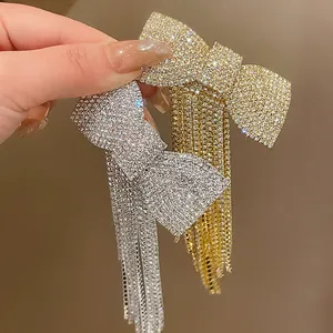 Close-up of sparkling rhinestone bow hair clips with elegant long tassels