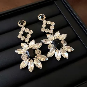 Elegant flower drop earrings with sparkling rhinestones and a central black gemstone