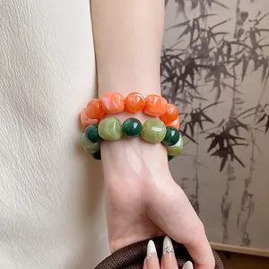 Close-up detail of colorful acrylic irregular geometric beaded bracelets worn on a wrist