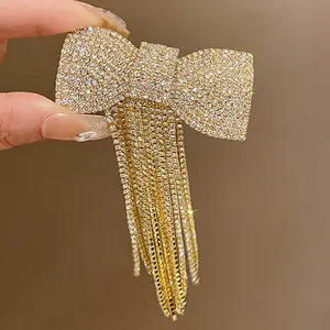 Detail view of sparkling rhinestone bow hair clip with elegant long tassels