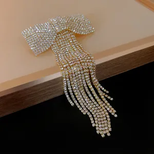 Macro view showing the sparkling rhinestone details of this elegant bow tassel hair clip