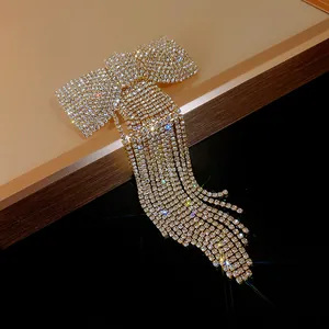 Close-up of sparkling rhinestone bow hair clip with elegant long tassel fringe detail