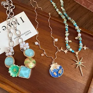 Elegant Bohemian pearl seashell and starburst pendant necklaces for beach vacations.