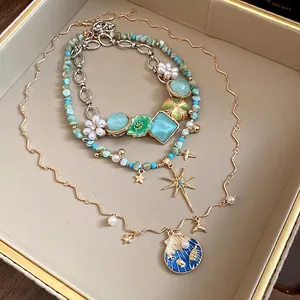 Elegant bohemian ocean themed necklace set with pearl shell flower and star pendants