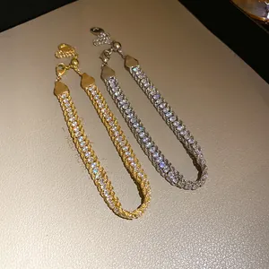 Macro view showing intricate detail of gold and silver rhinestone wrapped chain bracelets