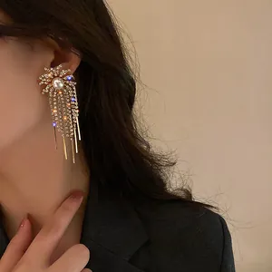 Close-up detail of exquisite tassel earrings with sparkling rhinestones and pearl