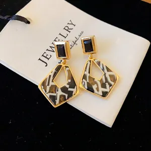 Geometric hollow earrings with silver needles and gold-tone finish in a square design