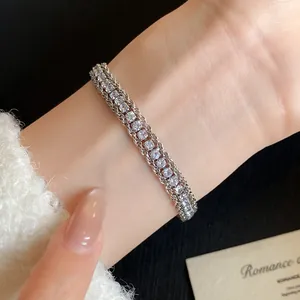 Detail shot of a sparkling vintage twisted chain bracelet worn on a female wrist