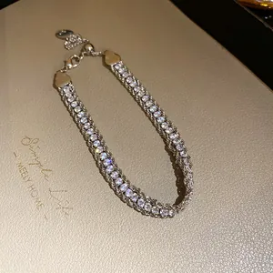 Close-up detail of luxury rhinestone wrapped chain bracelet with sparkling silver finish