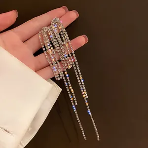 Close-up of sparkling silver-tone long tassel earrings with dense rhinestone details