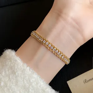 Close-up of vintage gold twisted chain bracelet with sparkling rhinestones on wrist