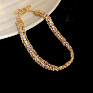 Close-up of elegant gold twisted chain bracelet with sparkling white crystals