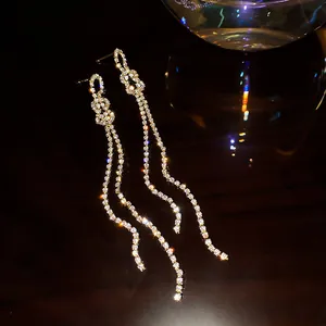 Close-up of elegant bowknot tassel earrings with shimmering full rhinestones