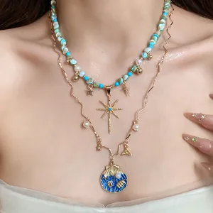 Detailed view of bohemian layered necklace with turquoise beads, stars, and shell pendant